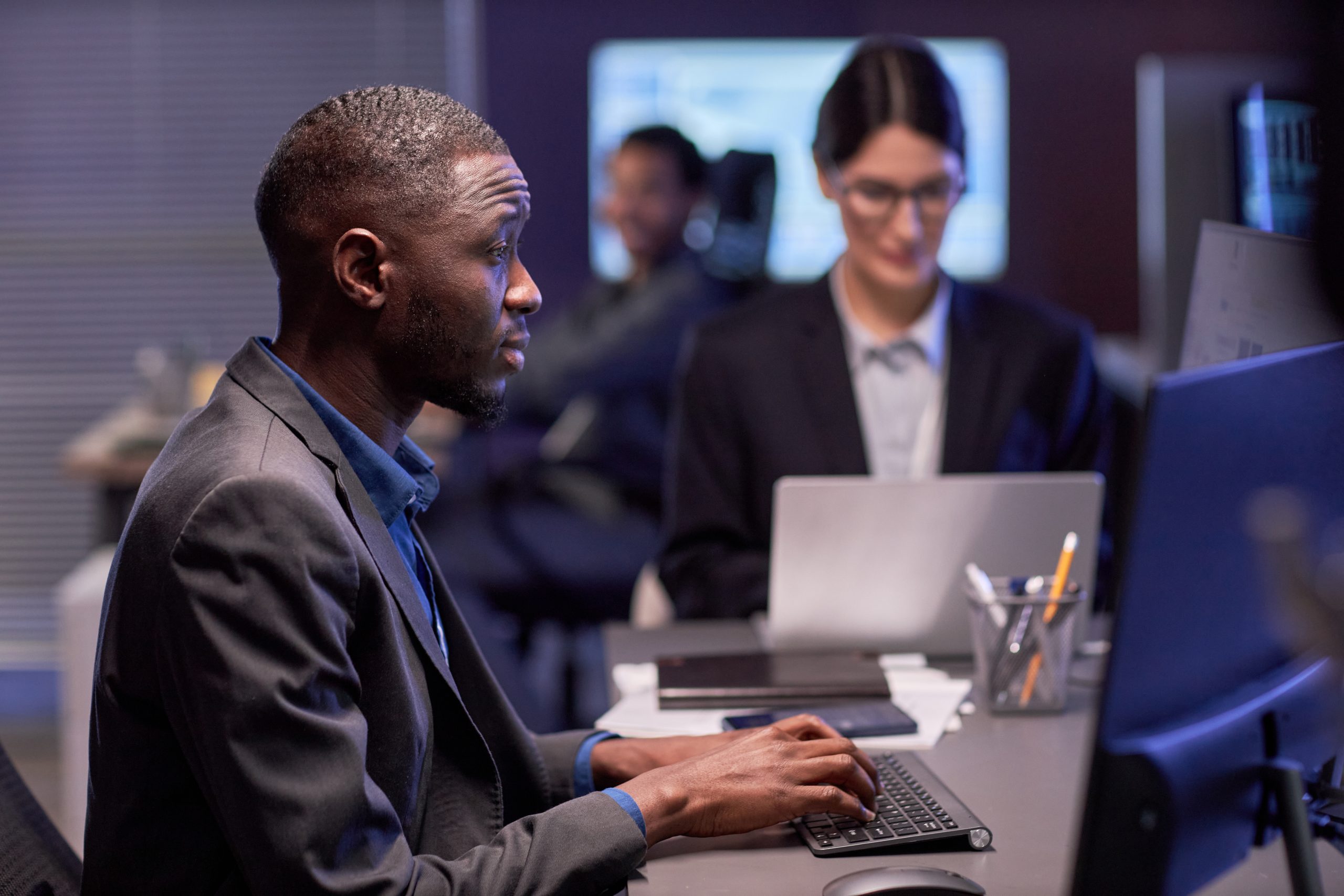 Serious black businessman using laptop at workplace in IT office Before performing outreach, be sure you investigate potential passive candidates for their technical signals such as their fit based on past work environments.